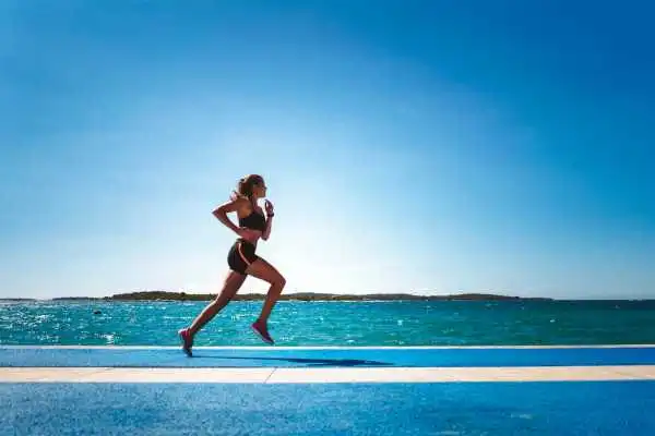 Woman running showing strong leg muscle Uckfield